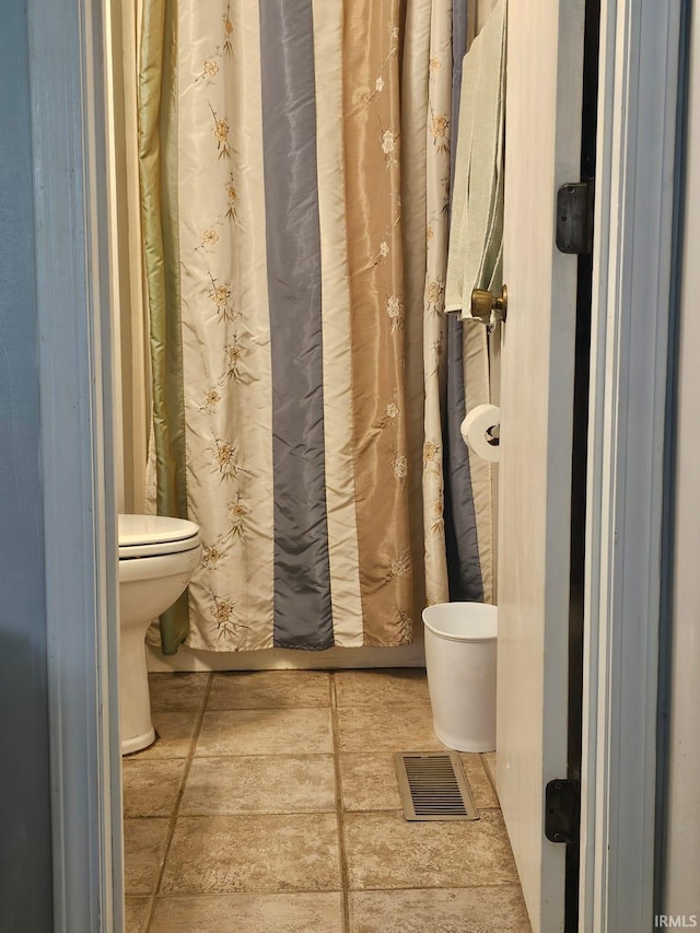 full bathroom with toilet and visible vents
