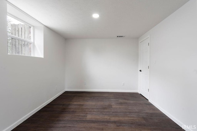 empty room with baseboards, recessed lighting, visible vents, and wood finished floors