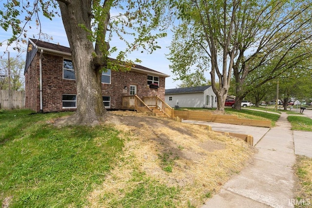 exterior space with brick siding and fence