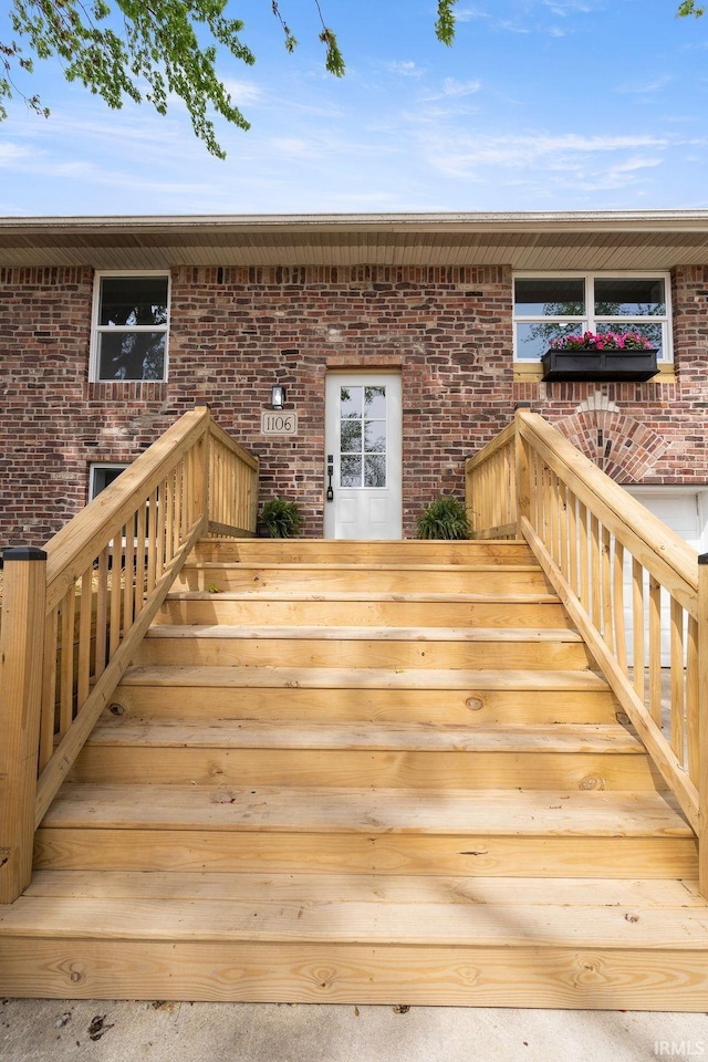 view of exterior entry with brick siding