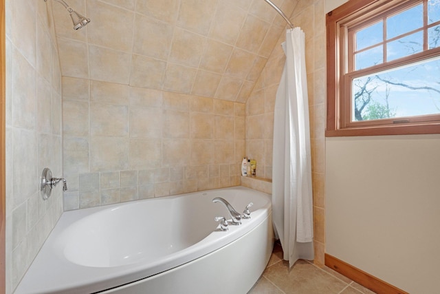 bathroom with baseboards, tile patterned floors, a shower with shower curtain, and a tub