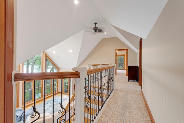 hall with light carpet, an upstairs landing, lofted ceiling, and recessed lighting