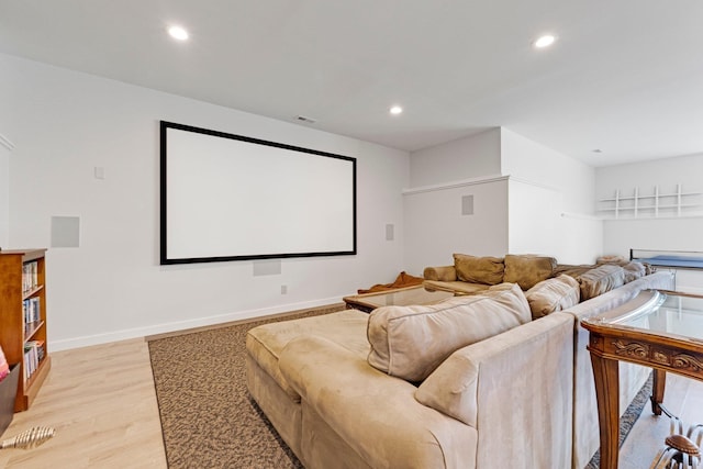 cinema room featuring light wood finished floors, baseboards, visible vents, and recessed lighting