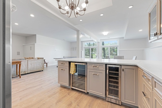 bar with beverage cooler, a chandelier, light wood-style flooring, and recessed lighting