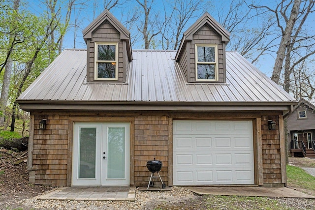 exterior space featuring metal roof, french doors, and a garage