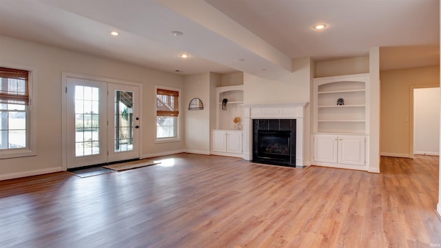 2122 Lakes Edge Dr, Newburgh, IN 47630 - unfurnished living room with a fireplace, built in features, baseboards, light wood-style floors, and recessed lighting