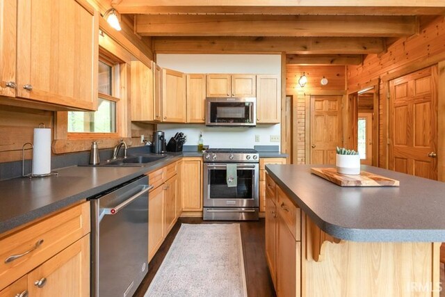 6705 S Shields Ridge Rd, Bloomington, IN 47401 - kitchen featuring light brown cabinetry, a sink, dark countertops, beam ceiling, and appliances with stainless steel finishes