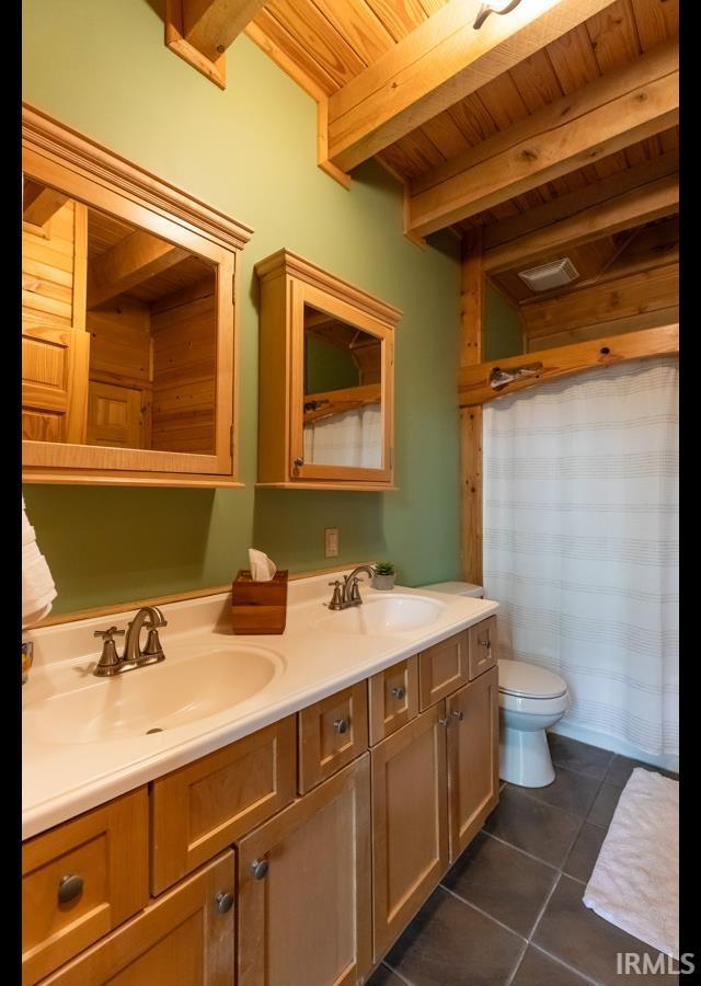6705 S Shields Ridge Rd, Bloomington, IN 47401 - bathroom featuring a sink, tile patterned flooring, wood ceiling, and beamed ceiling