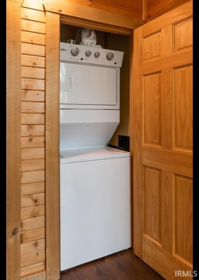 6705 S Shields Ridge Rd, Bloomington, IN 47401 - washroom featuring laundry area, dark wood-type flooring, and stacked washer and dryer