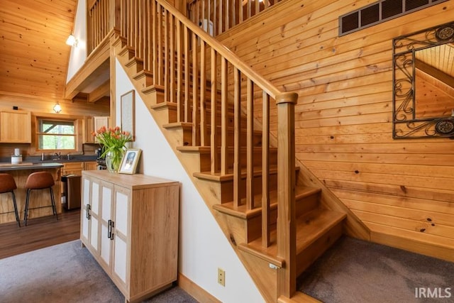 6705 S Shields Ridge Rd, Bloomington, IN 47401 - staircase featuring wood walls, visible vents, and carpet