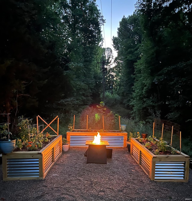 6705 S Shields Ridge Rd, Bloomington, IN 47401 - view of patio / terrace featuring a fire pit and a vegetable garden
