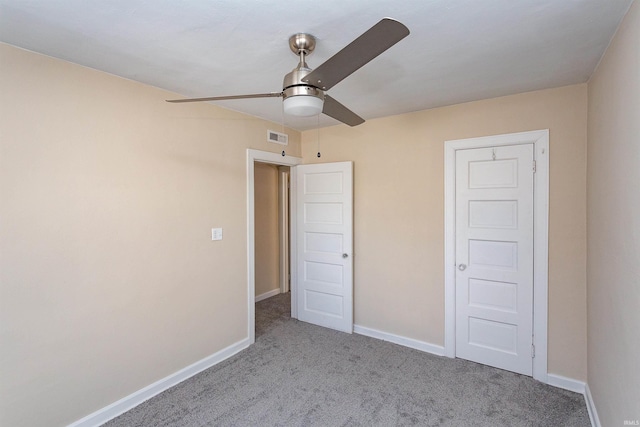 unfurnished bedroom with baseboards, ceiling fan, visible vents, and carpet