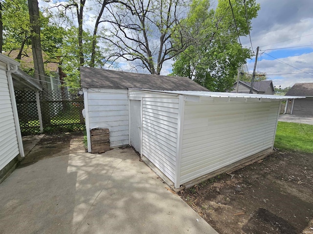 view of shed featuring fence