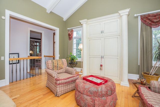 13 Rolling Ridge Ct, Jasper, IN 47546 - sitting room with an upstairs landing, decorative columns, lofted ceiling with beams, baseboards, and light wood-style floors