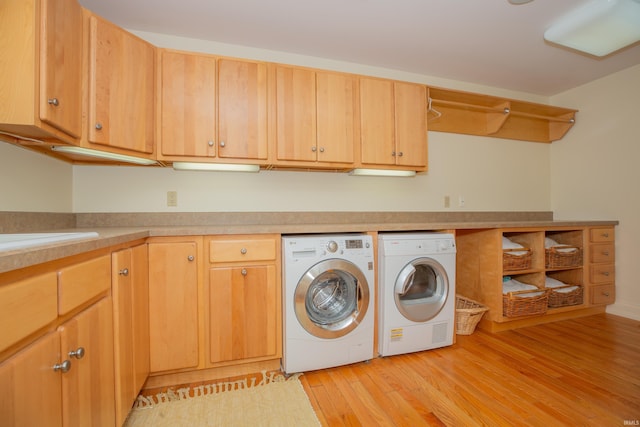 13 Rolling Ridge Ct, Jasper, IN 47546 - clothes washing area with light wood finished floors, independent washer and dryer, and cabinet space