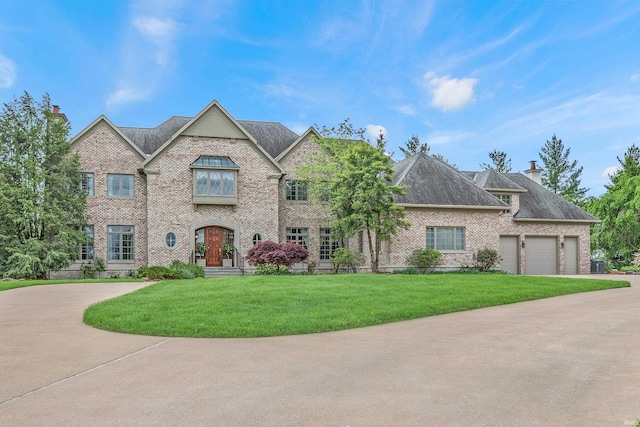 13 Rolling Ridge Ct, Jasper, IN 47546 - french provincial home with a front lawn, brick siding, driveway, and an attached garage