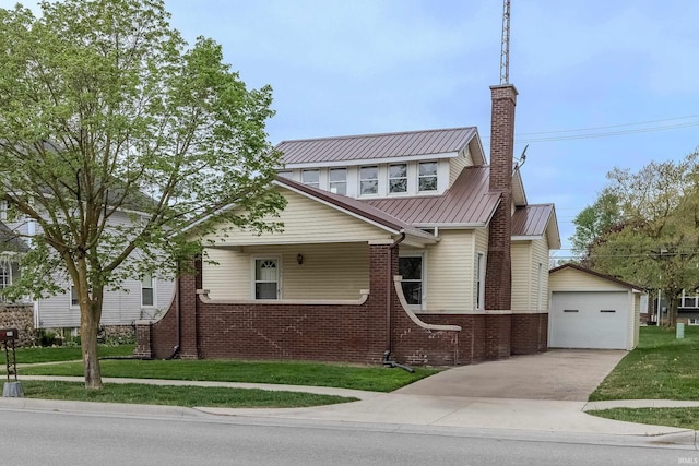 306 S Main St, Topeka, IN 46571 - view of front of house with driveway, brick siding, an outdoor structure, a detached garage, and a front lawn