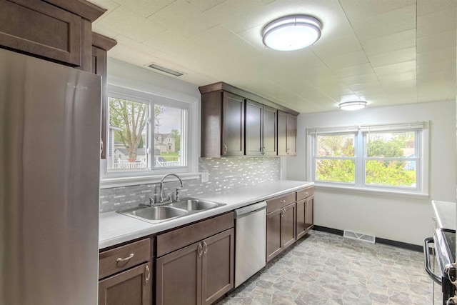 306 S Main St, Topeka, IN 46571 - kitchen with backsplash, appliances with stainless steel finishes, visible vents, and a sink