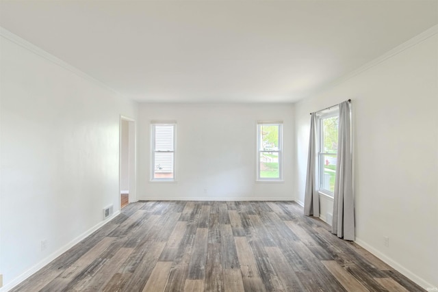 306 S Main St, Topeka, IN 46571 - unfurnished room featuring visible vents, baseboards, ornamental molding, and dark wood-style floors