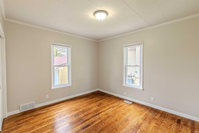 306 S Main St, Topeka, IN 46571 - spare room featuring crown molding, baseboards, visible vents, and light wood-style floors