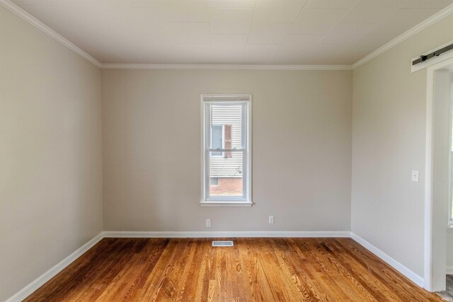 306 S Main St, Topeka, IN 46571 - spare room with light wood-type flooring, crown molding, and visible vents