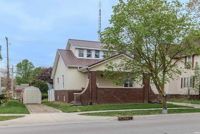 306 S Main St, Topeka, IN 46571 - bungalow-style house with brick siding, an outdoor structure, a shed, and a front yard