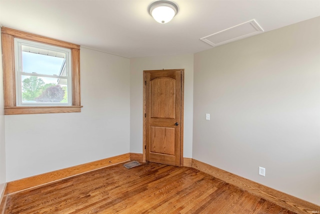 306 S Main St, Topeka, IN 46571 - unfurnished room with baseboards, attic access, visible vents, and wood finished floors