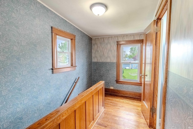 306 S Main St, Topeka, IN 46571 - corridor featuring light wood finished floors, plenty of natural light, an upstairs landing, and ornamental molding