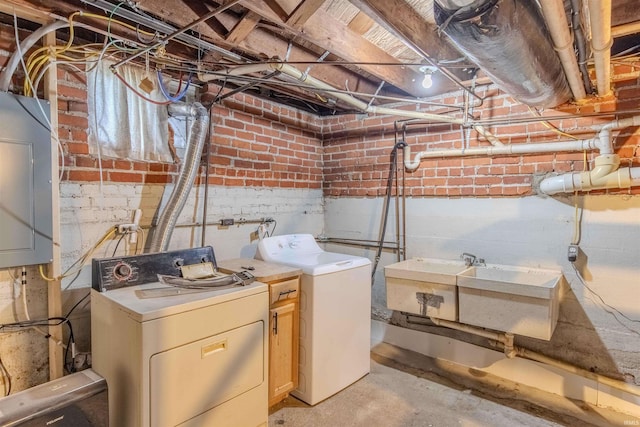 306 S Main St, Topeka, IN 46571 - laundry area with electric panel, laundry area, a sink, and washing machine and clothes dryer