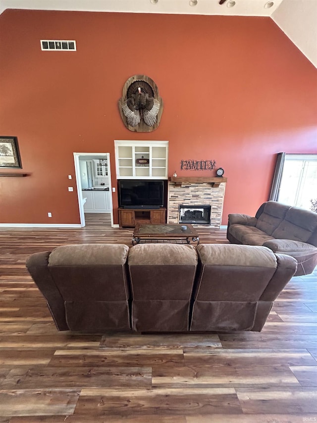 2034 County Road 68, Auburn, IN 46706 - living area with high vaulted ceiling, a fireplace, baseboards, and wood finished floors