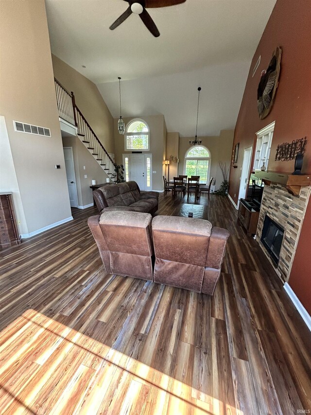 2034 County Road 68, Auburn, IN 46706 - living area with dark wood-type flooring, a fireplace, stairs, ceiling fan, and baseboards