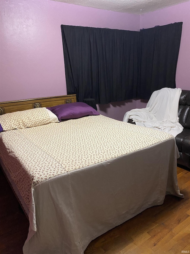 bedroom featuring wood finished floors