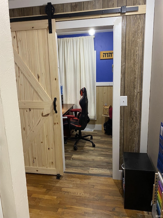 office space featuring wood finished floors and a barn door