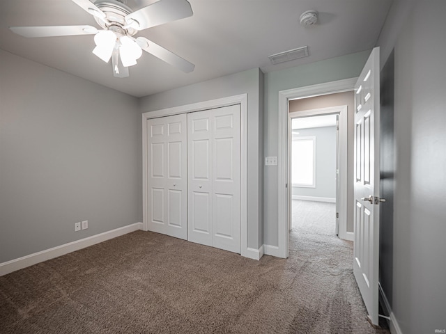 unfurnished bedroom featuring a closet, visible vents, baseboards, and carpet floors