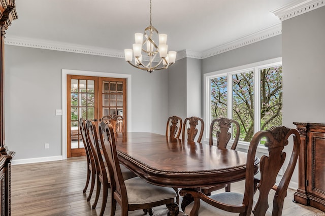 dining room featuring an inviting chandelier, light wood finished floors, and a healthy amount of sunlight