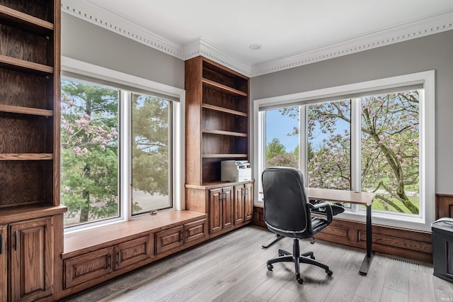 office with light wood finished floors and crown molding