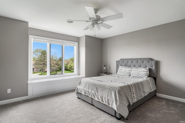 carpeted bedroom with baseboards and ceiling fan