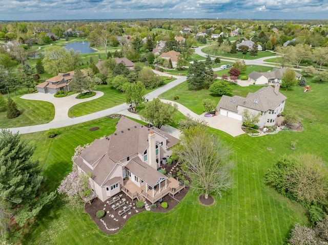 drone / aerial view featuring a water view and a residential view