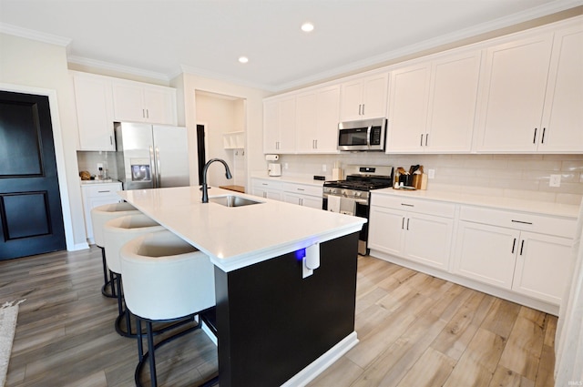 6357 Spirea Ct, West Lafayette, IN 47906 - kitchen featuring recessed lighting, a sink, crown molding, backsplash, and appliances with stainless steel finishes
