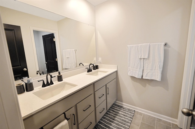 6357 Spirea Ct, West Lafayette, IN 47906 - bathroom featuring a sink, double vanity, and baseboards