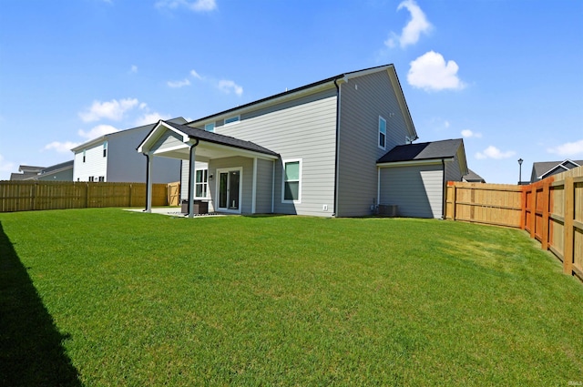 6357 Spirea Ct, West Lafayette, IN 47906 - back of house with a fenced backyard, central air condition unit, and a yard