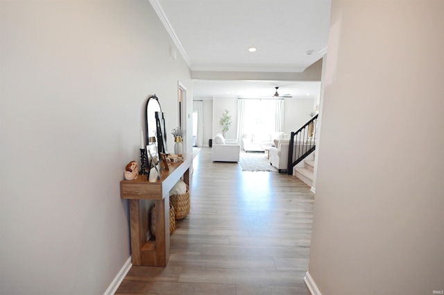 6357 Spirea Ct, West Lafayette, IN 47906 - hallway featuring stairway, wood finished floors, baseboards, and ornamental molding