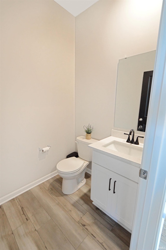 6357 Spirea Ct, West Lafayette, IN 47906 - half bath with toilet, baseboards, vanity, and wood finished floors
