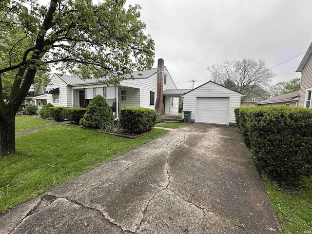 view of front of home with concrete driveway, a front lawn, and a chimney