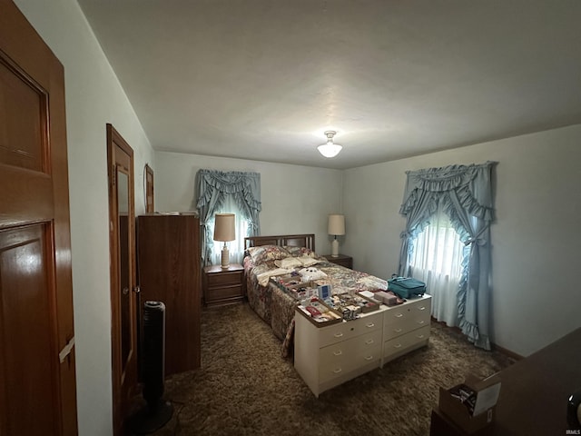 bedroom featuring dark colored carpet