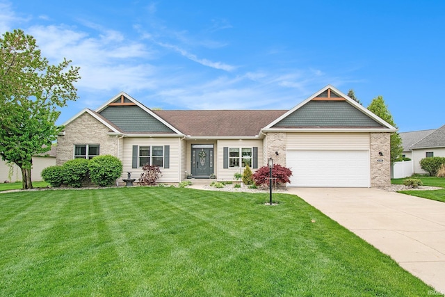view of front of house featuring an attached garage, concrete driveway, brick siding, and a front lawn