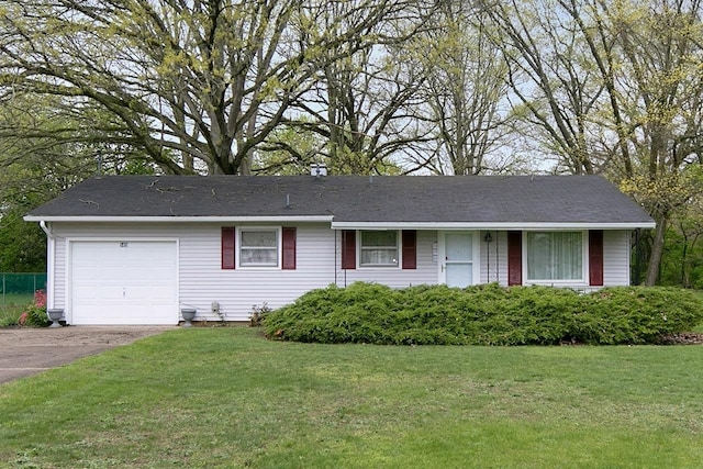 single story home with aphalt driveway, a front lawn, and an attached garage