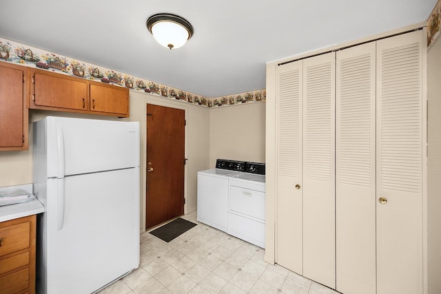 laundry area featuring light floors, laundry area, and washer and clothes dryer