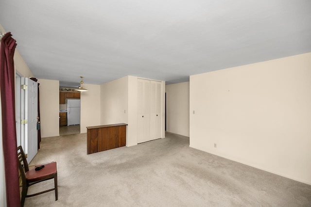 unfurnished living room with light carpet