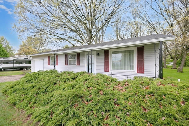 ranch-style house with driveway and a garage